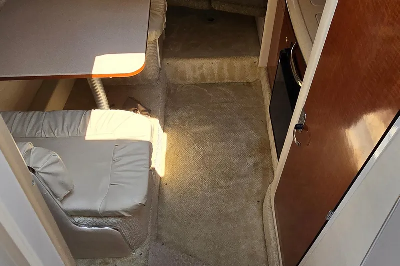Slide: The Image of Interior of 2003 Sea Ray 280 Sundancer with seating and table. - 19