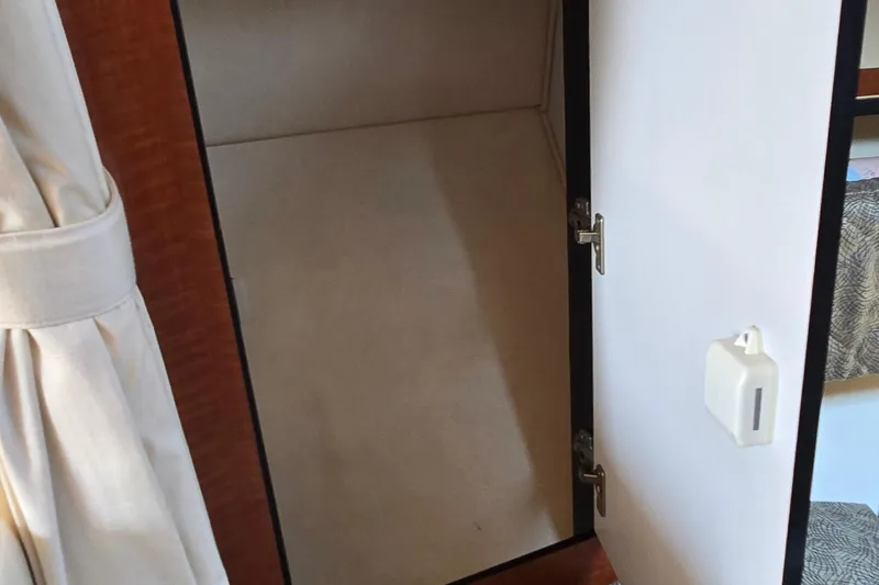 Slide: The Image of Open storage compartment inside 2003 Sea Ray 280 Sundancer boat. - 26