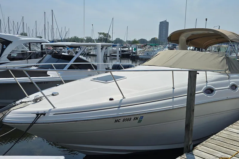 Slide: The Image of 2003 Sea Ray 280 Sundancer docked at marina with other boats. - 3
