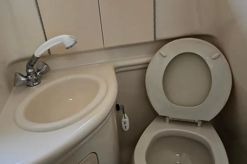 Slide: The Image of 2003 Sea Ray 280 Sundancer bathroom with sink and toilet. - 31