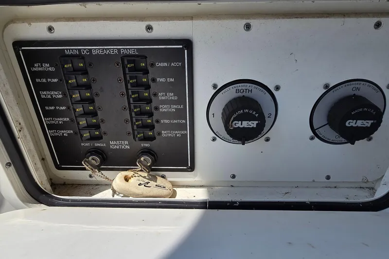 Slide: The Image of Control panel of a 2003 Sea Ray 280 Sundancer boat with switches and dials. - 36