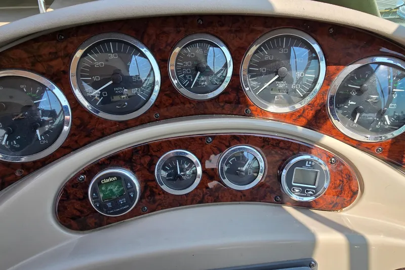 Slide: The Image of Dashboard of a 2003 Sea Ray 280 Sundancer boat with gauges and controls. - 7