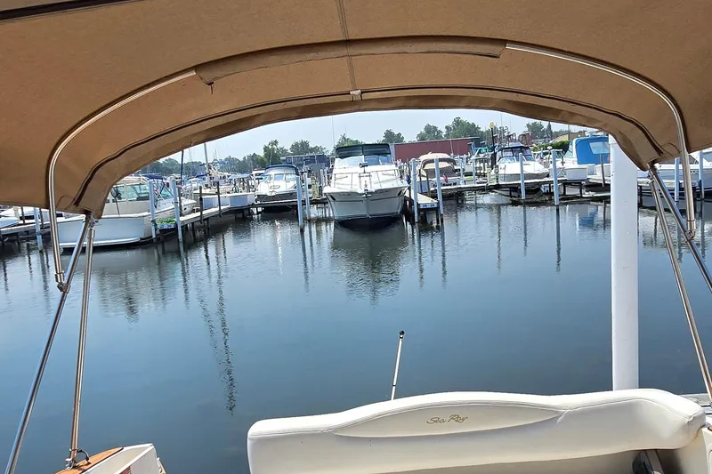 Slide: The Image of 2003 Sea Ray 280 Sundancer in marina, surrounded by boats and calm water. - 9