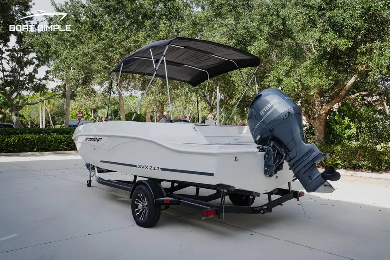 Slide: The Image of 2023 Starcraft SVX 211 OB boat on trailer, parked outdoors. - 1