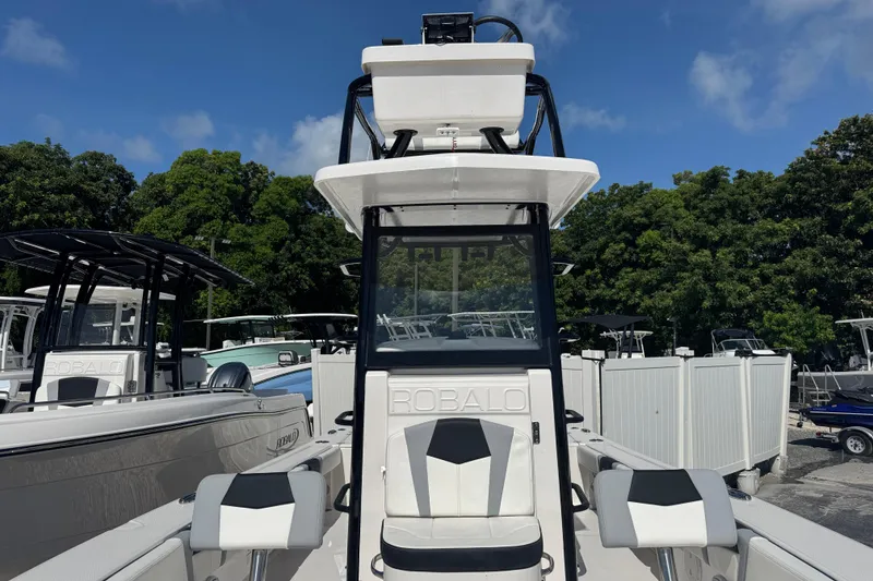 Slide: The Image of 2025 Robalo 246 Cayman SD boat with dual seating, sleek design, and modern features. - 14