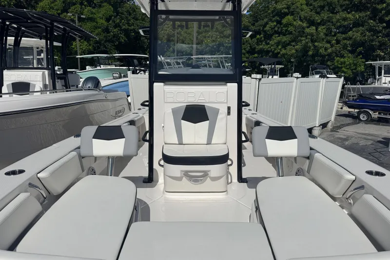 Slide: The Image of 2025 Robalo 246 Cayman SD boat interior with white seating and console. - 15