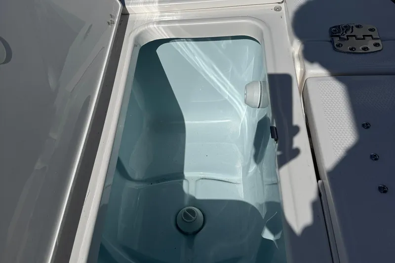 Slide: The Image of Livewell compartment on 2025 Robalo 246 Cayman SD boat, open lid view. - 21
