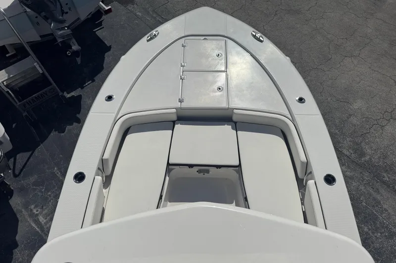 Slide: The Image of 2025 Robalo 246 Cayman SD boat deck with cushioned seating and storage compartments. - 23