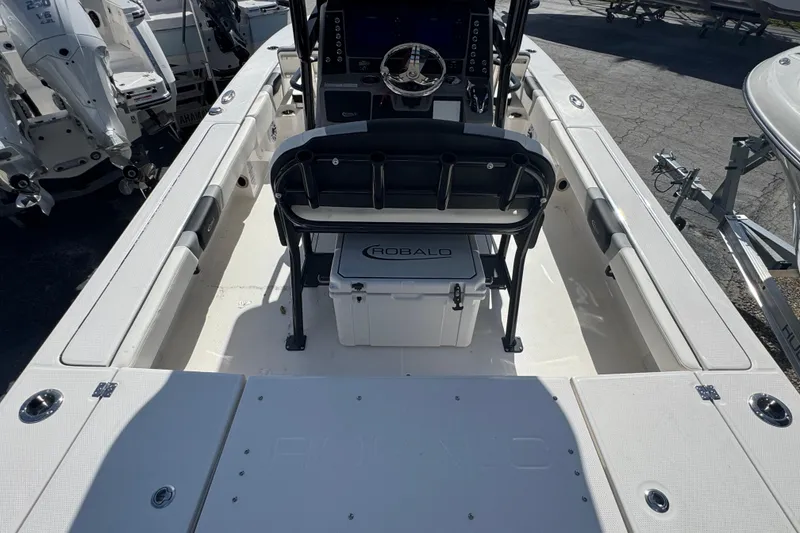 Slide: The Image of 2025 Robalo 246 Cayman SD boat interior with seating and console. - 3