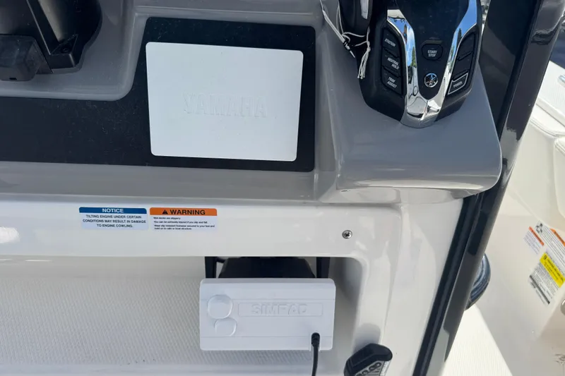 Slide: The Image of 2025 Robalo 246 Cayman SD boat dashboard with Yamaha controls and Simrad device. - 7