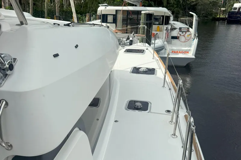 Slide: The Image of 2022 Lagoon 40 catamaran docked, showcasing sleek deck design and modern features. - 12
