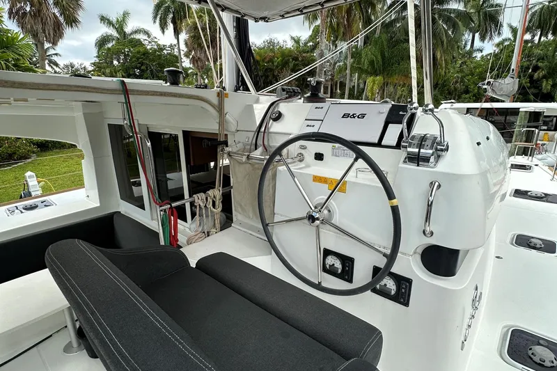 Slide: The Image of Cockpit of 2022 Lagoon 40 catamaran with steering wheel and navigation equipment. - 13