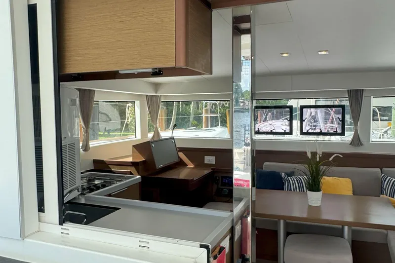 Slide: The Image of Modern interior of 2022 Lagoon 40 catamaran with kitchen and seating area. - 23