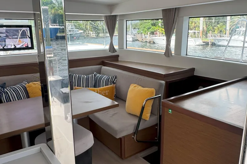 Slide: The Image of Interior of 2022 Lagoon 40 catamaran with cozy seating and large windows. - 24