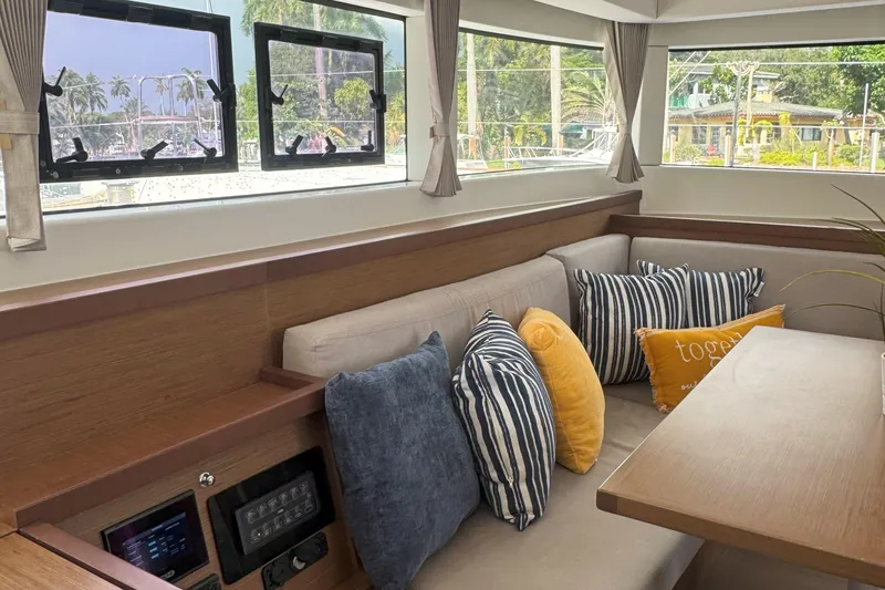Slide: The Image of Interior of 2022 Lagoon 40 yacht with cozy seating and decorative pillows. - 26