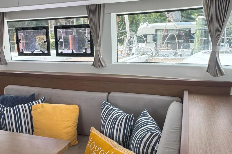 Slide: The Image of Interior of 2022 Lagoon 40 yacht with cozy seating and decorative pillows. - 30