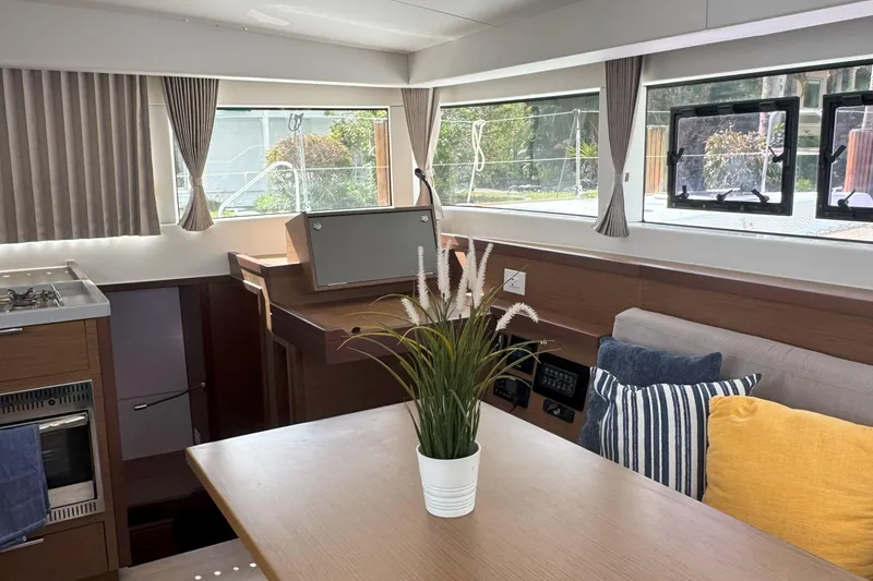 Slide: The Image of Interior of 2022 Lagoon 40 yacht with modern decor and large windows. - 31