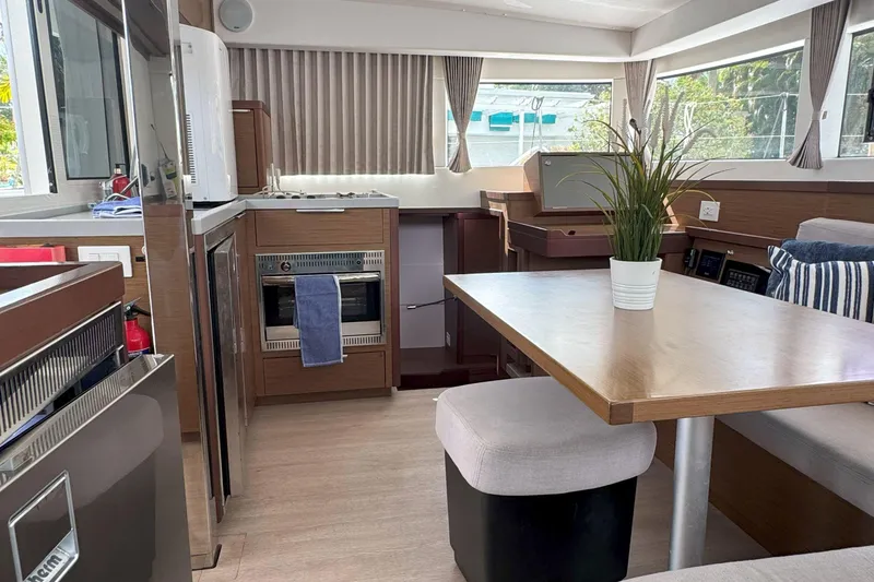 Slide: The Image of Modern interior of 2022 Lagoon 40 catamaran with kitchen and dining area. - 32