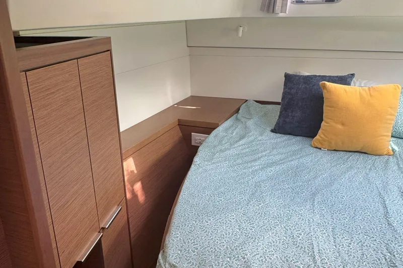 Slide: The Image of Cozy cabin interior of 2022 Lagoon 40 catamaran with bed and pillows. - 38