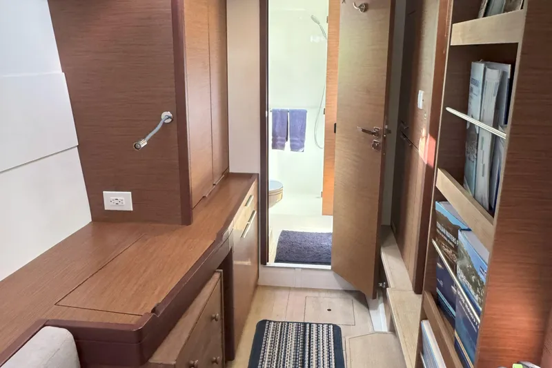 Slide: The Image of Interior of 2022 Lagoon 40 yacht with wooden cabinetry and bathroom view. - 40