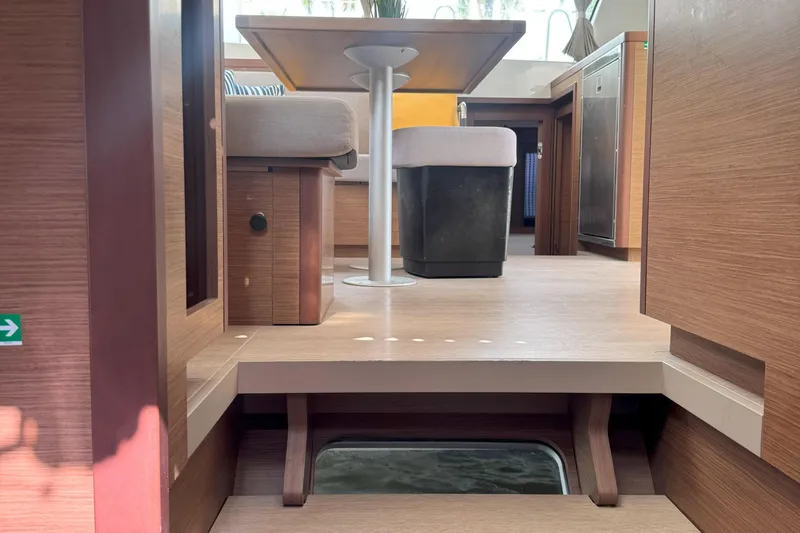 Slide: The Image of Interior of 2022 Lagoon 40 catamaran, featuring modern wood finish and seating area. - 43