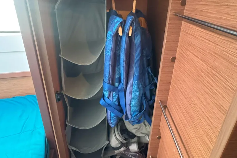 Slide: The Image of Storage area in 2022 Lagoon 40 yacht with hanging backpacks and shelves. - 46