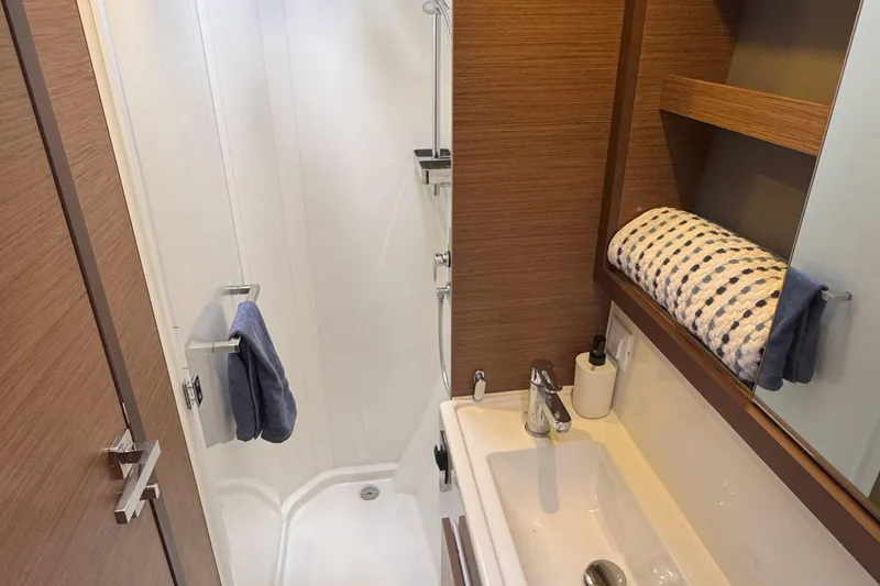 Slide: The Image of Modern bathroom in 2022 Lagoon 40 yacht with shower, sink, and wooden accents. - 47