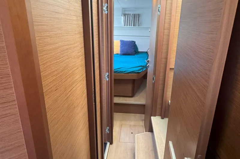 Slide: The Image of Interior of 2022 Lagoon 40 yacht, featuring a cozy cabin with wooden finishes. - 49