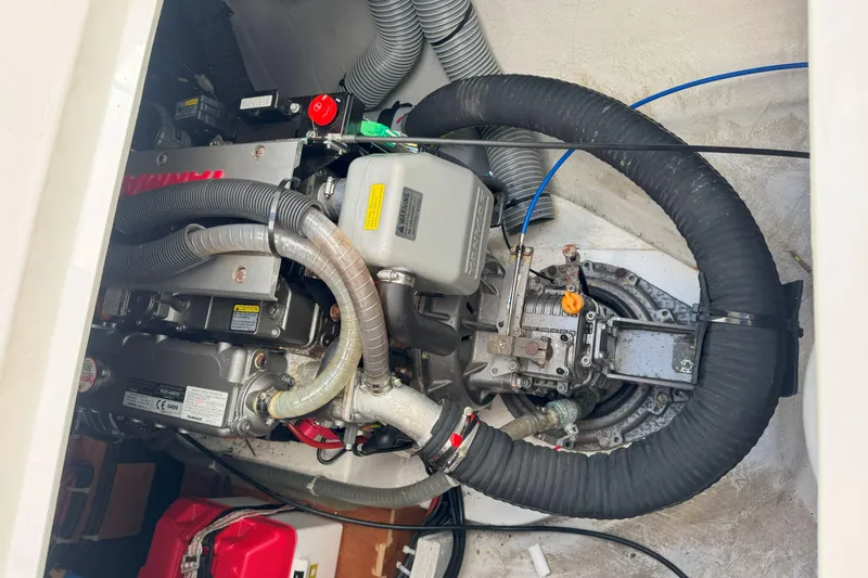 Slide: The Image of Engine compartment of a 2022 Lagoon 40 catamaran, featuring mechanical components and hoses. - 52