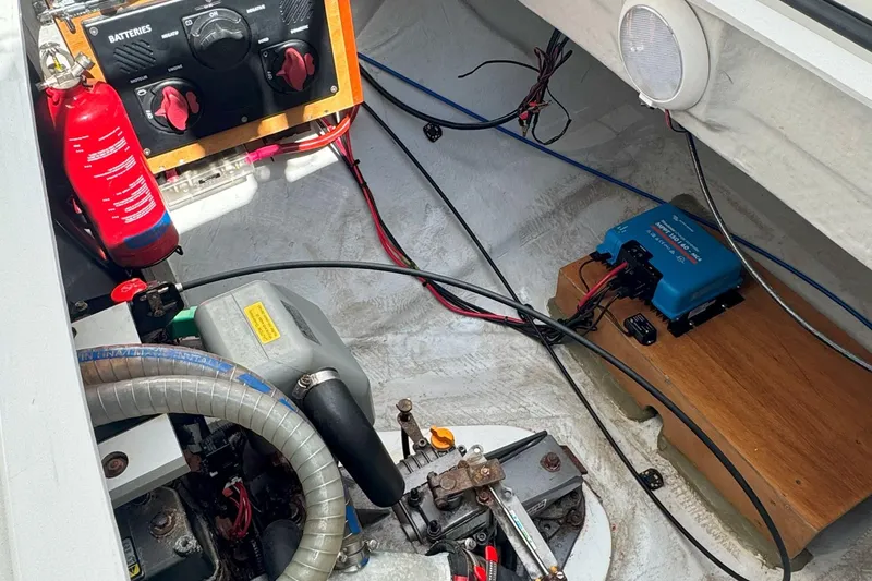Slide: The Image of Engine compartment of a 2022 Lagoon 40 catamaran with battery controls and fire extinguisher. - 53