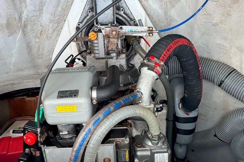 Slide: The Image of Engine compartment of a 2022 Lagoon 40 catamaran, showcasing hoses and mechanical components. - 54