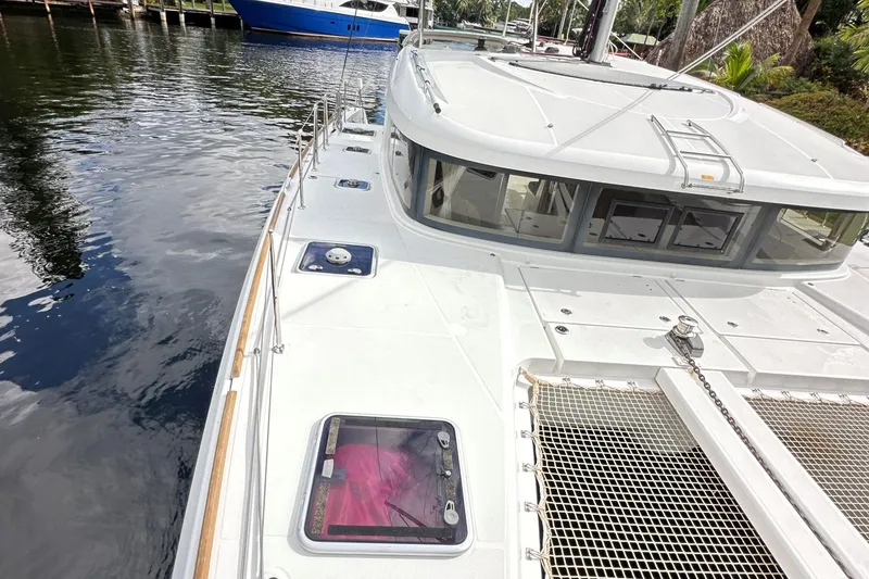Slide: The Image of 2022 Lagoon 40 catamaran docked, showcasing sleek design and spacious deck. - 7