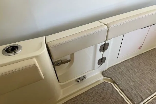 Slide: The Image of 2026 Chris-Craft Catalina 31 interior detail, featuring beige seating and storage compartments. - 11