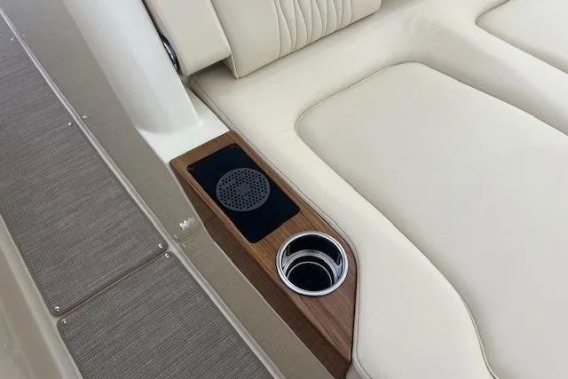 Slide: The Image of 2026 Chris-Craft Catalina 31 interior with beige seating, wood accents, and cup holder. - 13