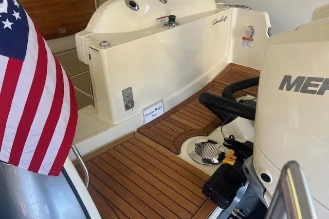 Slide: The Image of 2026 Chris-Craft Catalina 31 boat with American flag and teak deck. - 6