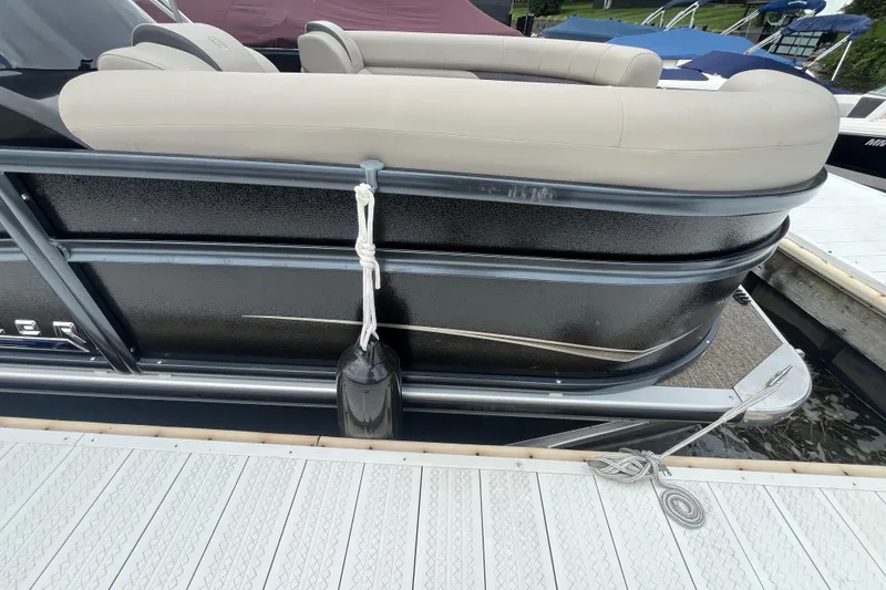 Slide: The Image of 2020 Premier 230 SunSation RF pontoon boat docked with fender and rope. - 27