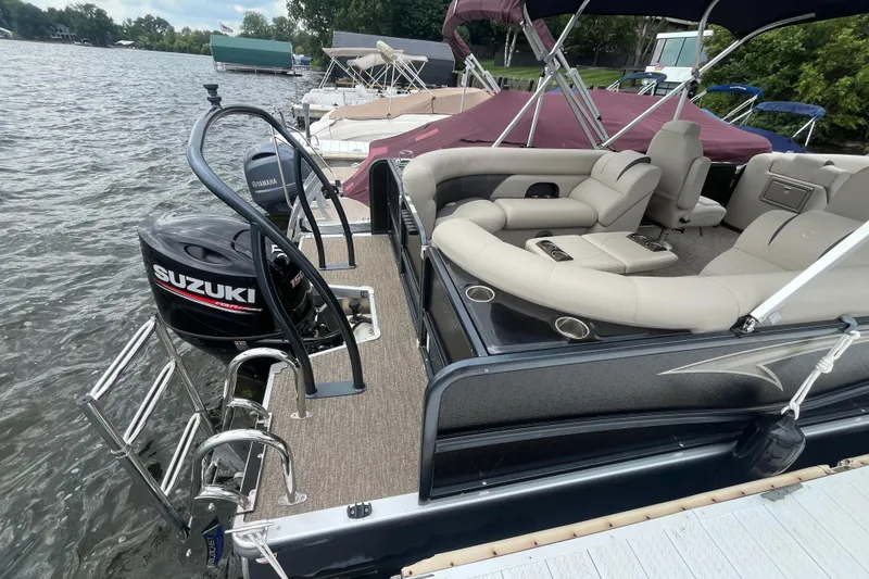 Slide: The Image of 2020 Premier 230 SunSation RF pontoon boat with Suzuki outboard motor docked by the lake. - 28