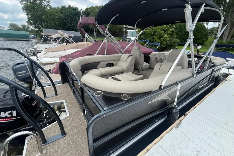 Slide: The Image of 2020 Premier 230 SunSation RF pontoon boat docked, featuring spacious seating and canopy. - 29
