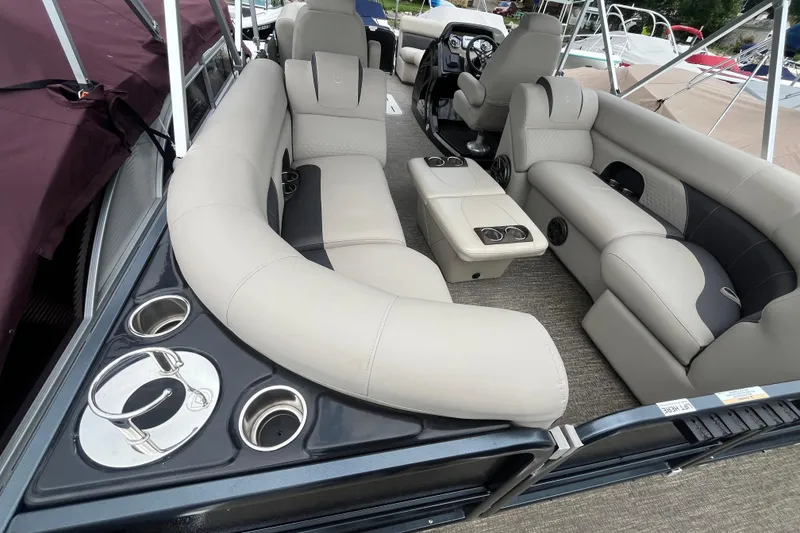 Slide: The Image of Luxurious seating on 2020 Premier 230 SunSation RF pontoon boat with cup holders. - 31