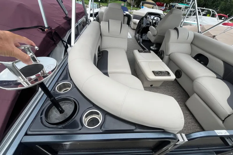Slide: The Image of 2020 Premier 230 SunSation RF pontoon boat interior with plush seating and cup holders. - 32