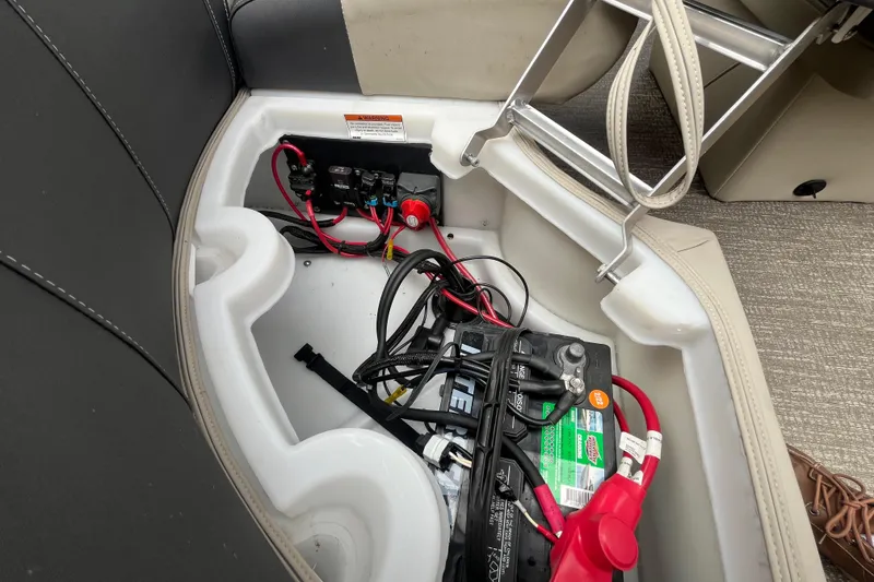 Slide: The Image of Battery compartment of 2020 Premier 230 SunSation RF boat with wiring and connections. - 33