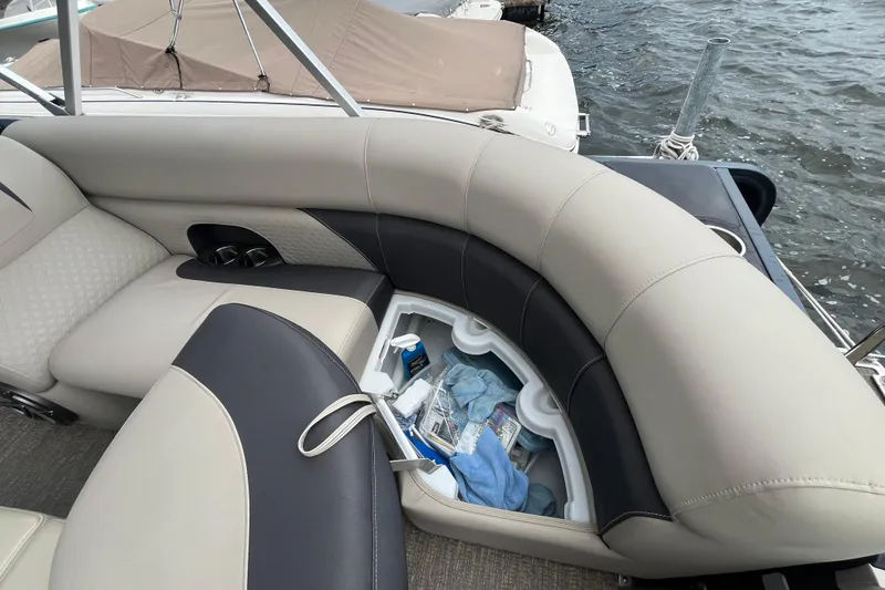 Slide: The Image of Premier 230 SunSation RF 2020 boat with open storage compartment and luxurious seating. - 34