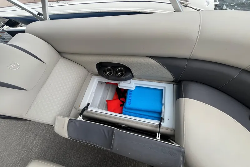 Slide: The Image of 2020 Premier 230 SunSation RF boat seat storage with cup holders and safety equipment. - 35