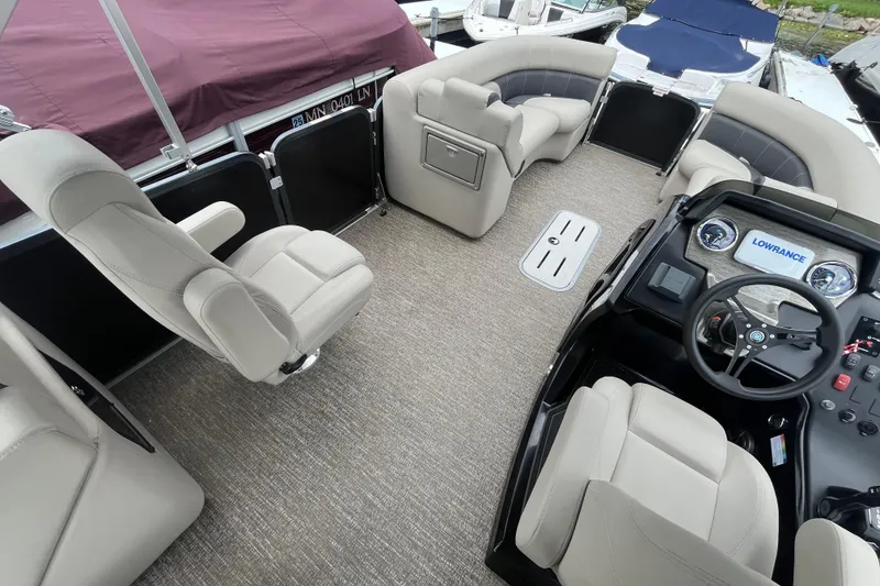 Slide: The Image of 2020 Premier 230 SunSation RF pontoon boat interior with plush seating and modern dashboard. - 37