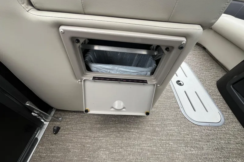 Slide: The Image of Built-in trash compartment on 2020 Premier 230 SunSation RF boat interior. - 38