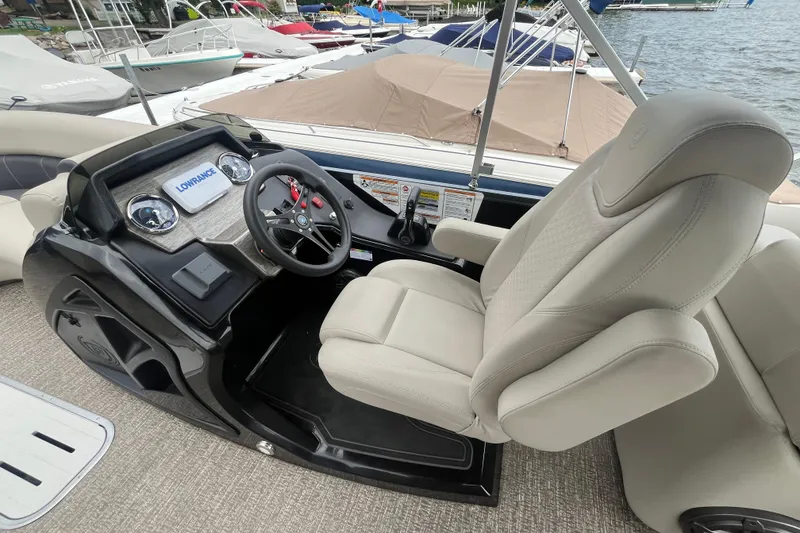 Slide: The Image of Captain's seat and helm of 2020 Premier 230 SunSation RF pontoon boat, featuring Lowrance electronics. - 41