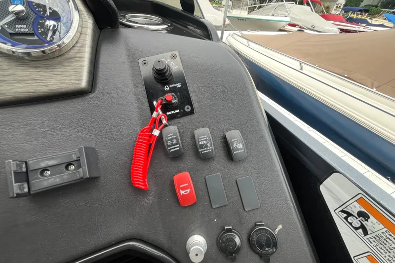 Slide: The Image of Control panel of 2020 Premier 230 SunSation RF boat with switches and red safety lanyard. - 45
