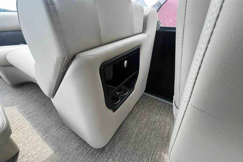 Slide: The Image of 2020 Premier 230 SunSation RF boat interior with beige seating and cup holders. - 50