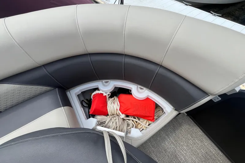 Slide: The Image of 2020 Premier 230 SunSation RF boat seat storage with ropes and red life jackets. - 55
