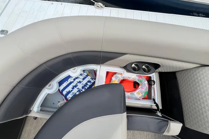 Slide: The Image of Interior storage of 2020 Premier 230 SunSation RF boat with life jackets and cup holders. - 58
